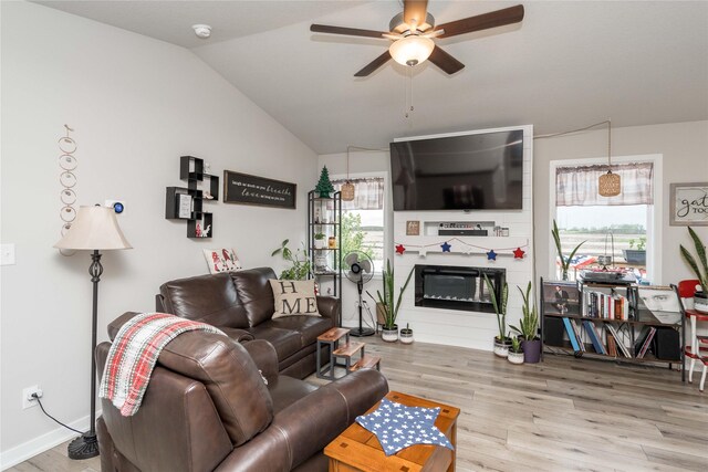 1165 Locust St, Waukee, IA 50263 - living area featuring a ceiling fan, wood finished floors, a large fireplace, and lofted ceiling
