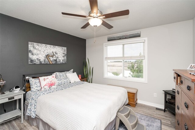 1165 Locust St, Waukee, IA 50263 - bedroom featuring light wood finished floors and a ceiling fan