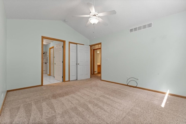 130 NW Georgetown Blvd Unit 4, Ankeny, IA 50023 - unfurnished bedroom featuring carpet, vaulted ceiling, connected bathroom, ceiling fan, and a closet