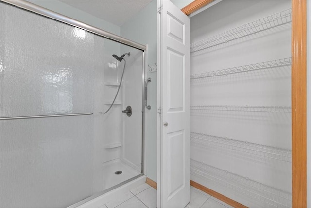 130 NW Georgetown Blvd Unit 4, Ankeny, IA 50023 - full bathroom with a shower stall, tile patterned flooring, and a spacious closet