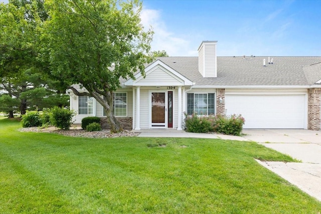 130 NW Georgetown Blvd Unit 4, Ankeny, IA 50023 - view of front of home featuring brick siding, a garage, a front lawn, driveway, and a chimney