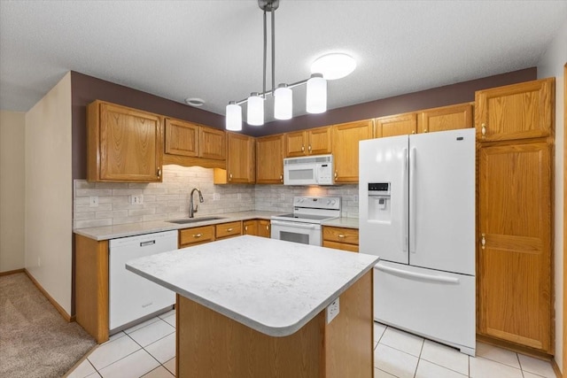 130 NW Georgetown Blvd Unit 4, Ankeny, IA 50023 - kitchen featuring white appliances, light countertops, backsplash, a kitchen island, and light tile patterned flooring