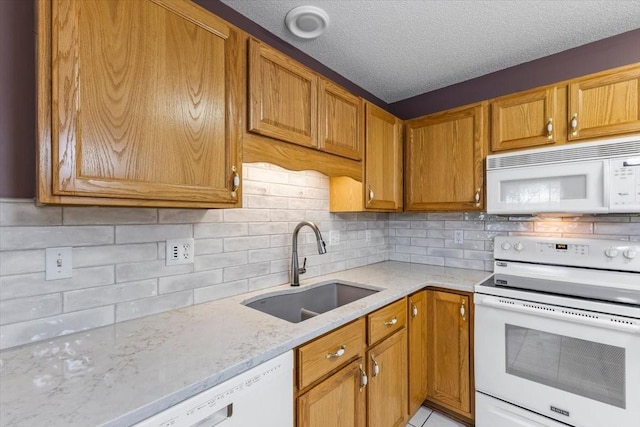 130 NW Georgetown Blvd Unit 4, Ankeny, IA 50023 - kitchen featuring white appliances, light stone countertops, backsplash, brown cabinetry, and a textured ceiling