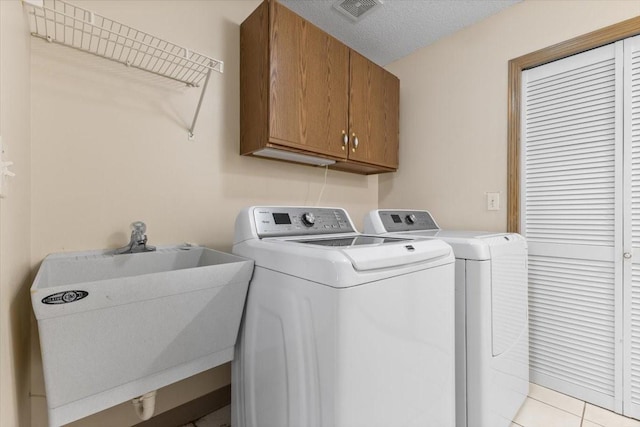 130 NW Georgetown Blvd Unit 4, Ankeny, IA 50023 - laundry area with separate washer and dryer, cabinet space, and light tile patterned flooring