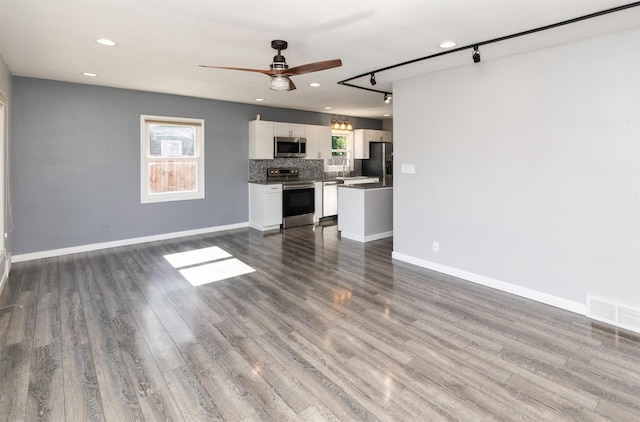 1808 Payton Ave, Des Moines, IA 50315 - unfurnished living room with ceiling fan, plenty of natural light, dark wood-type flooring, and recessed lighting