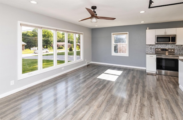 1808 Payton Ave, Des Moines, IA 50315 - unfurnished living room with dark wood finished floors, recessed lighting, and a ceiling fan