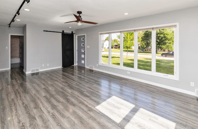 1808 Payton Ave, Des Moines, IA 50315 - unfurnished living room featuring a barn door, a ceiling fan, track lighting, healthy amount of natural light, and recessed lighting