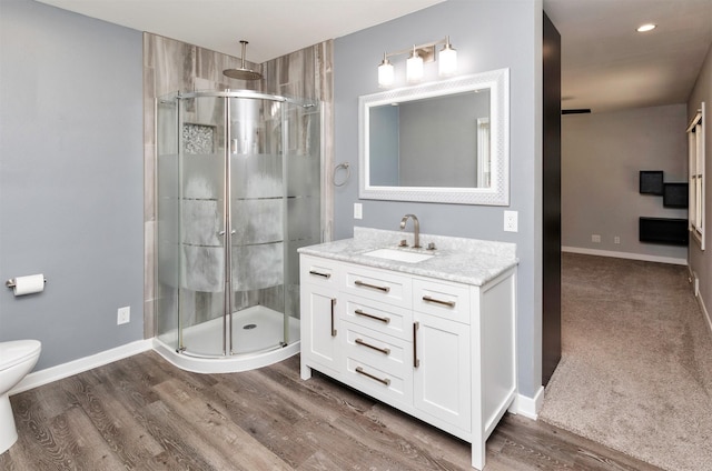 1808 Payton Ave, Des Moines, IA 50315 - bathroom with a shower stall, vanity, wood finished floors, and recessed lighting