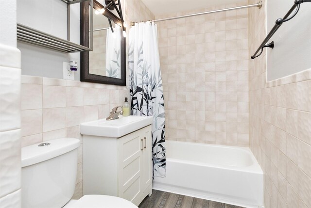 1808 Payton Ave, Des Moines, IA 50315 - bathroom featuring tile walls, vanity, shower / bath combination with curtain, and wood finished floors