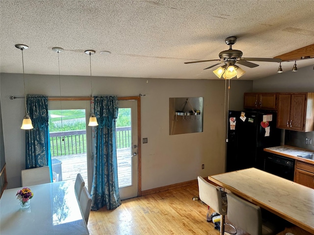 3521 SE 20th St, Des Moines, IA 50320 - kitchen with black appliances, light wood-style floors, ceiling fan, a textured ceiling, and brown cabinetry