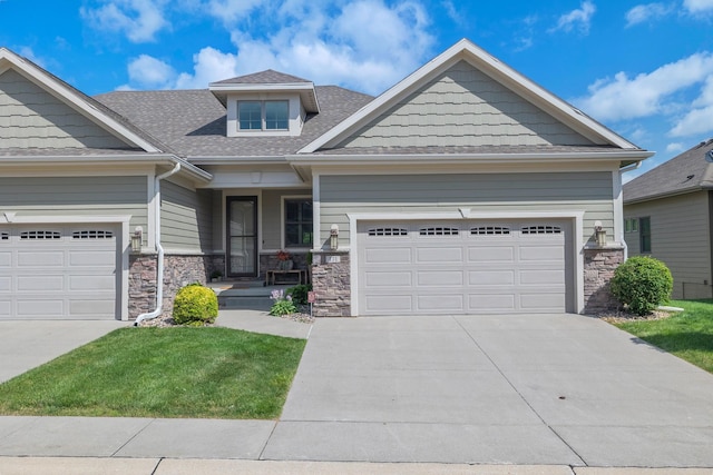 255 S 41st St Unit 171, West Des Moines, IA 50265 - craftsman house with stone siding, concrete driveway, a garage, a shingled roof, and a front yard