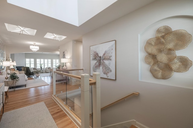 255 S 41st St Unit 171, West Des Moines, IA 50265 - hallway with a skylight, an upstairs landing, light wood-style floors, and a chandelier