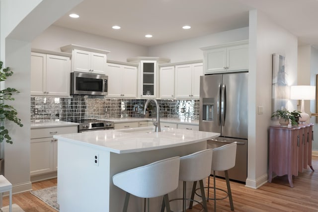 255 S 41st St Unit 171, West Des Moines, IA 50265 - kitchen with appliances with stainless steel finishes, decorative backsplash, light wood-style floors, light countertops, and recessed lighting