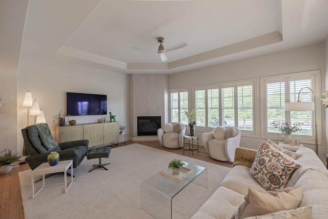 255 S 41st St Unit 171, West Des Moines, IA 50265 - living area featuring a raised ceiling, wood finished floors, a ceiling fan, and a large fireplace