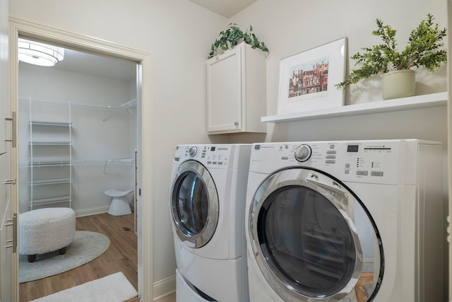 255 S 41st St Unit 171, West Des Moines, IA 50265 - laundry area with cabinet space, independent washer and dryer, and wood finished floors