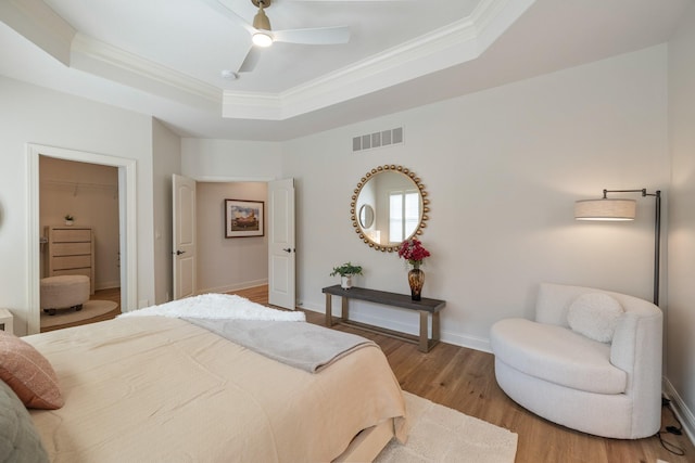 255 S 41st St Unit 171, West Des Moines, IA 50265 - bedroom with a tray ceiling, ornamental molding, wood finished floors, and a ceiling fan