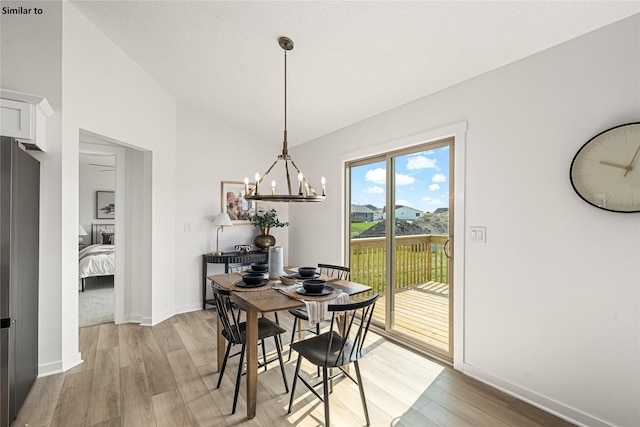 1620 NW Jackson Dr, Ankeny, IA 50023 - dining room featuring a chandelier, light wood-type flooring, and lofted ceiling