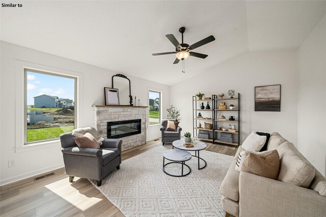 1620 NW Jackson Dr, Ankeny, IA 50023 - living area featuring light wood-type flooring, a fireplace, lofted ceiling, and a ceiling fan