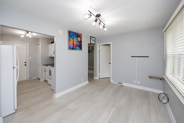 3416 Garfield Ave, Des Moines, IA 50317 - unfurnished dining area with light wood finished floors and a chandelier