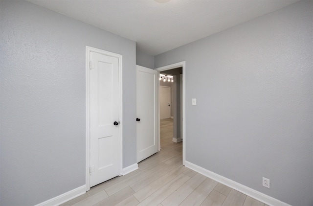 3416 Garfield Ave, Des Moines, IA 50317 - unfurnished bedroom with baseboards and light wood finished floors