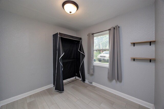 3416 Garfield Ave, Des Moines, IA 50317 - workout room featuring baseboards and light wood finished floors