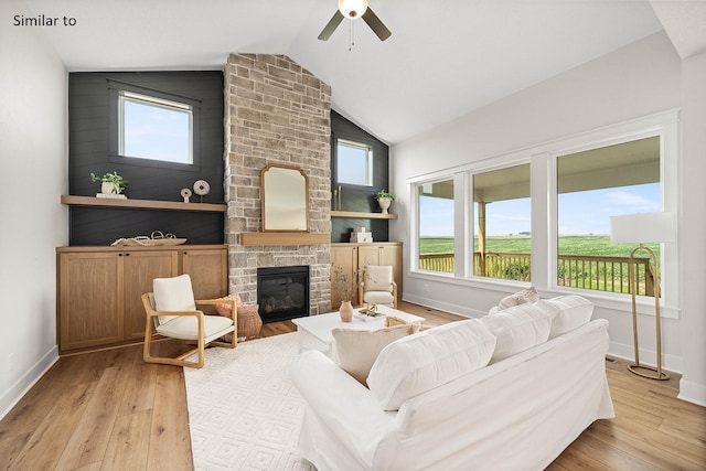 2281 Green Leaf Cir, Norwalk, IA 50211 - living room featuring wood finished floors, lofted ceiling, a fireplace, and a ceiling fan