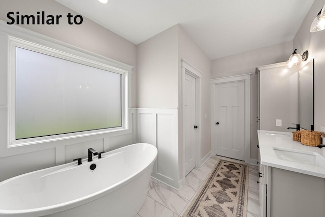 2281 Green Leaf Cir, Norwalk, IA 50211 - bathroom with a soaking tub, double vanity, marble look tile flooring, and wainscoting