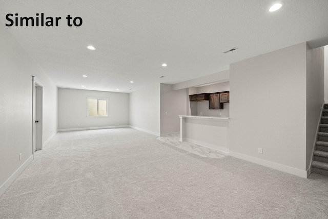 2281 Green Leaf Cir, Norwalk, IA 50211 - unfurnished living room with light colored carpet, stairs, and recessed lighting