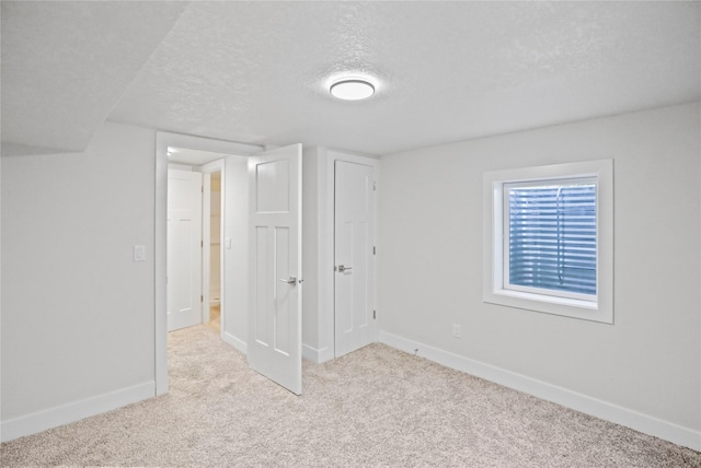 2420 E 37th St, Des Moines, IA 50317 - unfurnished bedroom with a textured ceiling and carpet