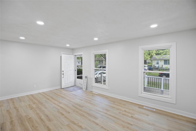2420 E 37th St, Des Moines, IA 50317 - unfurnished room featuring plenty of natural light, recessed lighting, and light wood-style flooring