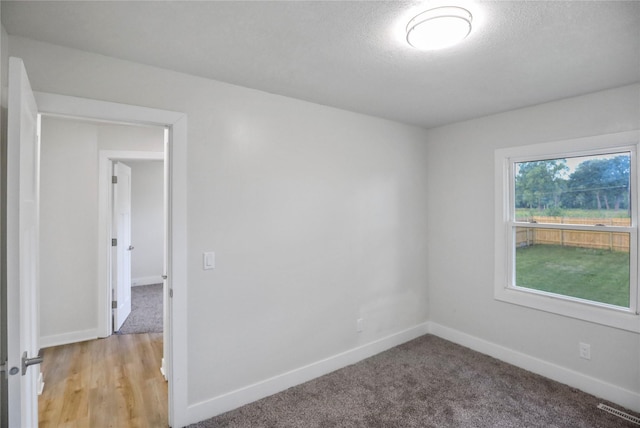 2420 E 37th St, Des Moines, IA 50317 - spare room featuring a textured ceiling and light colored carpet