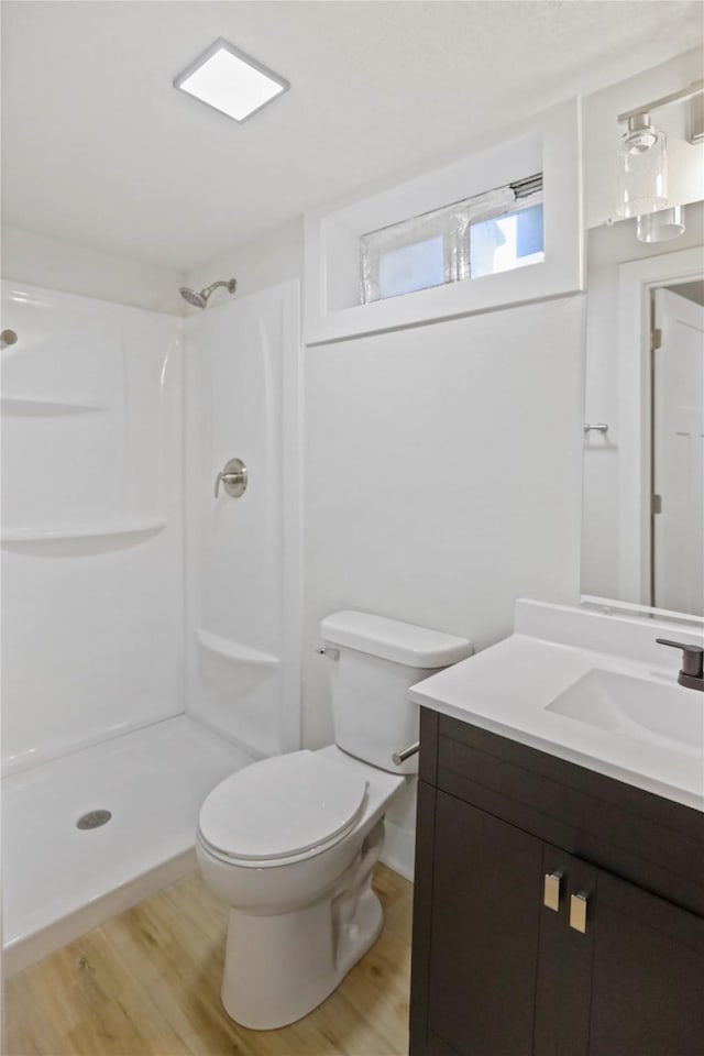 2420 E 37th St, Des Moines, IA 50317 - full bath featuring vanity, wood finished floors, and a shower