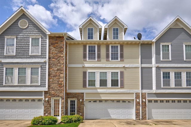 8302 Westown Pkwy Unit 3102, West Des Moines, IA 50266 - townhome / multi-family property featuring stone siding, driveway, and an attached garage