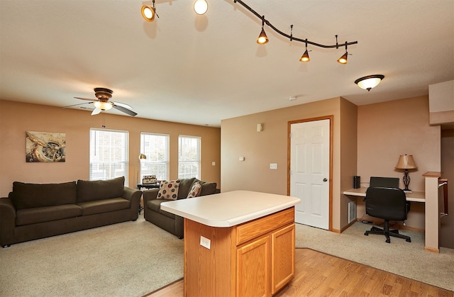 8302 Westown Pkwy Unit 3102, West Des Moines, IA 50266 - kitchen featuring open floor plan, ceiling fan, a desk, and light countertops