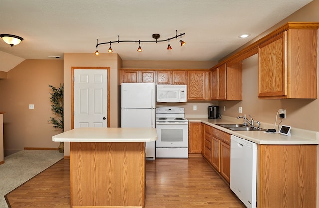 8302 Westown Pkwy Unit 3102, West Des Moines, IA 50266 - kitchen with white appliances, light wood finished floors, a kitchen island, light countertops, and vaulted ceiling