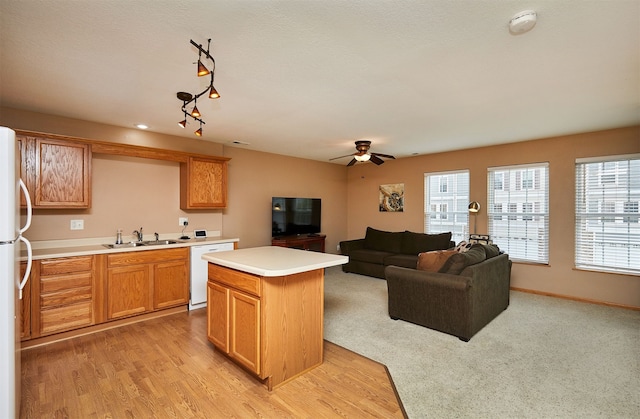 8302 Westown Pkwy Unit 3102, West Des Moines, IA 50266 - kitchen featuring white appliances, a center island, light countertops, a ceiling fan, and open floor plan