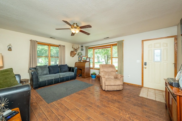 605 Grand St, New Virginia, IA 50210 - living area with a ceiling fan, wood finished floors, and a textured ceiling