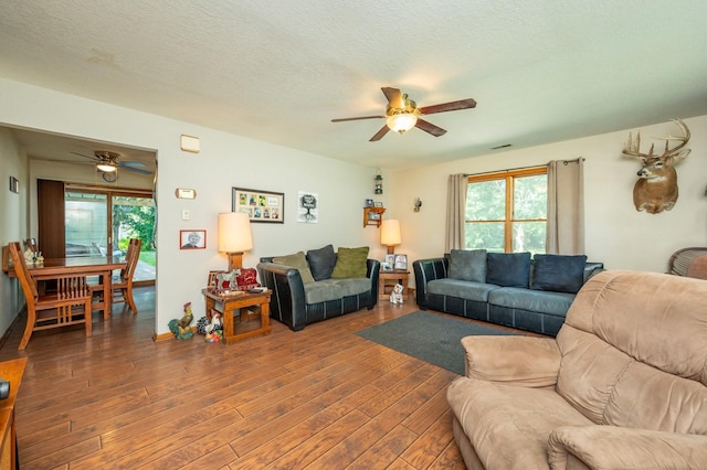605 Grand St, New Virginia, IA 50210 - living area featuring a ceiling fan, wood finished floors, and a textured ceiling