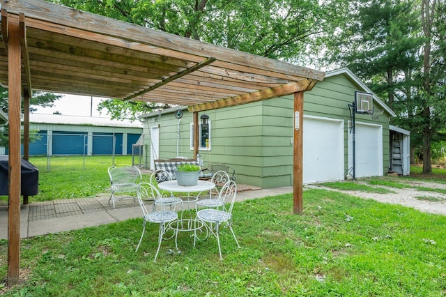605 Grand St, New Virginia, IA 50210 - view of patio with a detached garage and a pergola