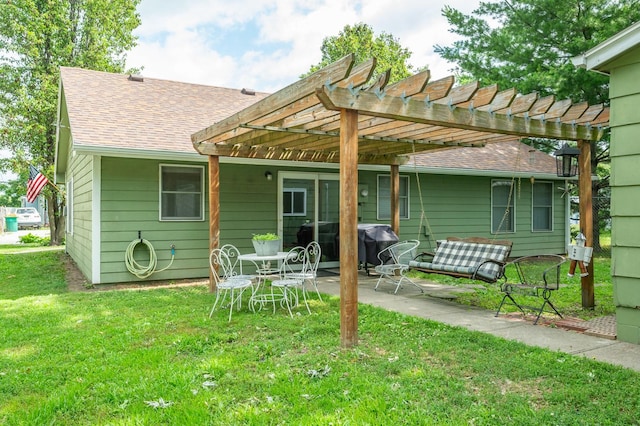 605 Grand St, New Virginia, IA 50210 - rear view of house featuring a pergola, roof with shingles, a lawn, and a patio