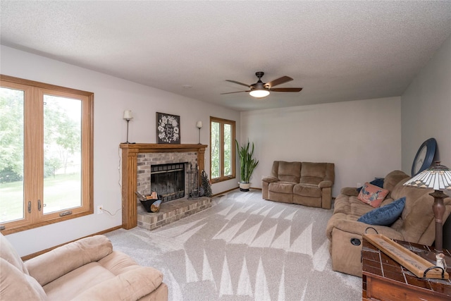 130 SW Meadowlark Ct, Ankeny, IA 50023 - living area featuring ceiling fan, a textured ceiling, carpet flooring, and a brick fireplace
