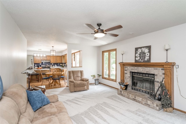 130 SW Meadowlark Ct, Ankeny, IA 50023 - living room with light carpet, a brick fireplace, a ceiling fan, a textured ceiling, and a chandelier