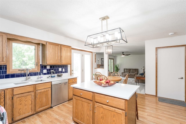 130 SW Meadowlark Ct, Ankeny, IA 50023 - kitchen with stainless steel dishwasher, light wood-type flooring, a ceiling fan, and decorative backsplash