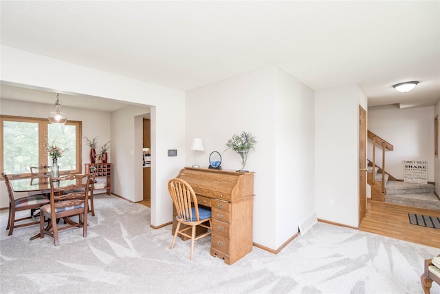 130 SW Meadowlark Ct, Ankeny, IA 50023 - dining room featuring light carpet and stairway