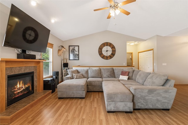 1701 2nd Ave SW, Altoona, IA 50009 - living room with a fireplace, vaulted ceiling, a ceiling fan, and light wood-type flooring