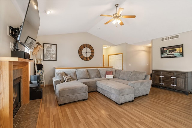 1701 2nd Ave SW, Altoona, IA 50009 - living room with wood finished floors, ceiling fan, lofted ceiling, and a tiled fireplace