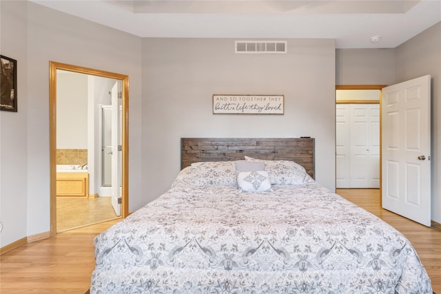 1701 2nd Ave SW, Altoona, IA 50009 - bedroom featuring light wood-style floors and ensuite bath