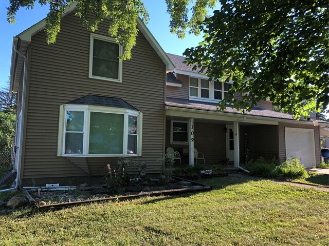 109 E Jackson St, Panora, IA 50216 - traditional-style house featuring a front lawn and a garage