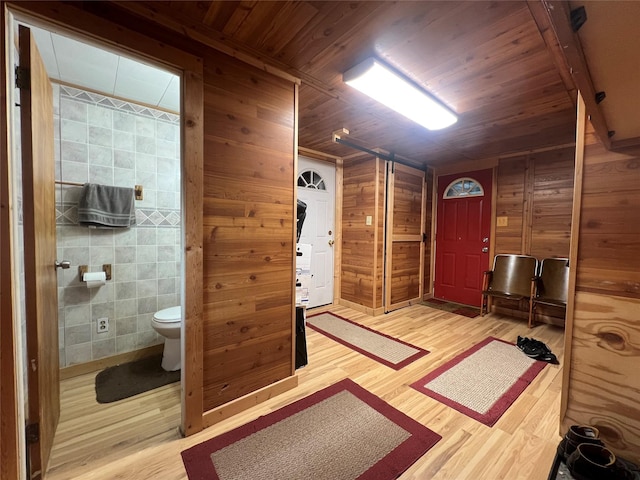 109 E Jackson St, Panora, IA 50216 - foyer entrance featuring wood finished floors, wooden ceiling, wood walls, and tile walls