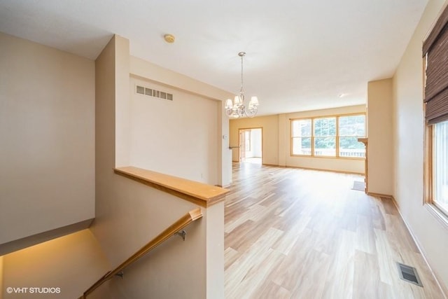 8318 Boulder Dr, West Des Moines, IA 50266 - hall featuring a chandelier and light wood finished floors